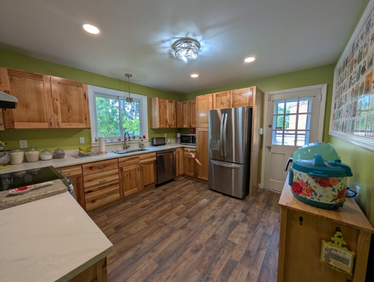 Signature series kitchen in Whitehall featuring new LVL flooring, hickory cabinets, and new countertops